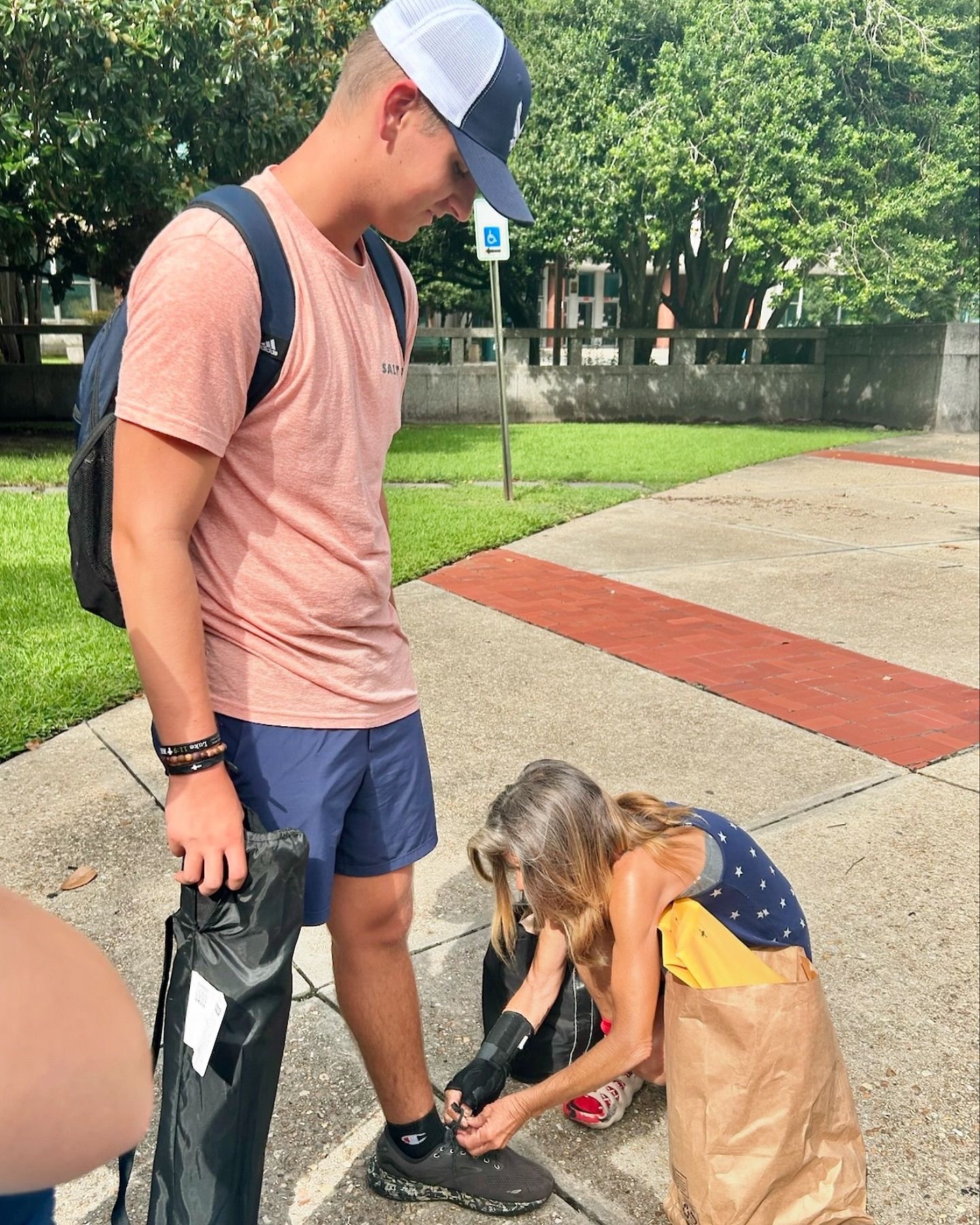 Photo for A Homeless Woman Tying a Shoe - New Orleans Mission Trip 2024